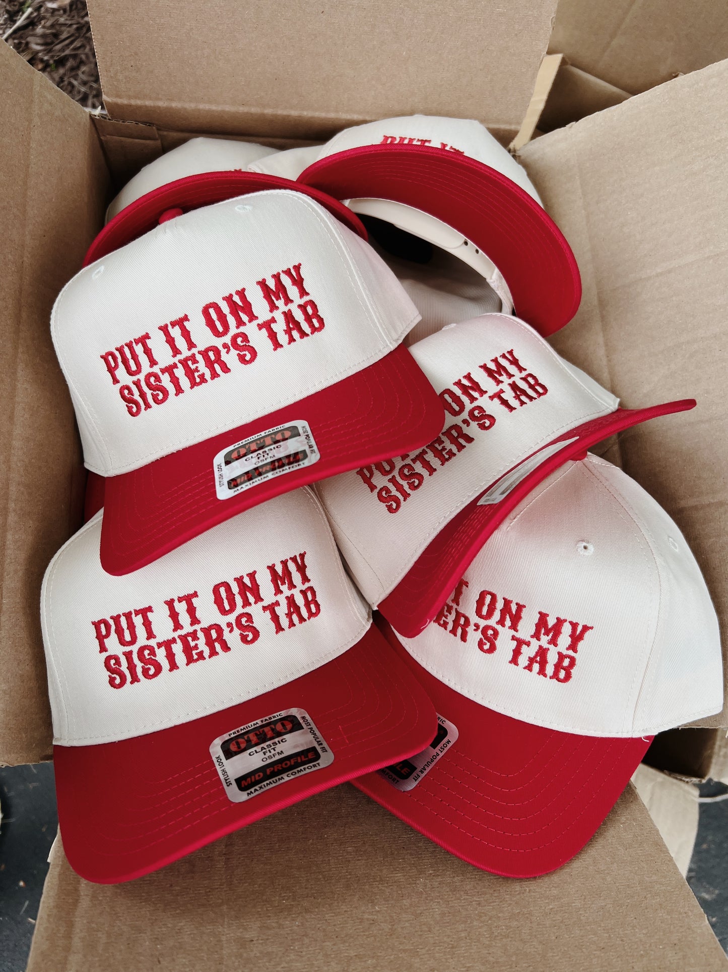 Put It On My Sisters Tab Trucker Hat